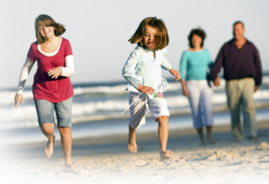 Family Running On Beach