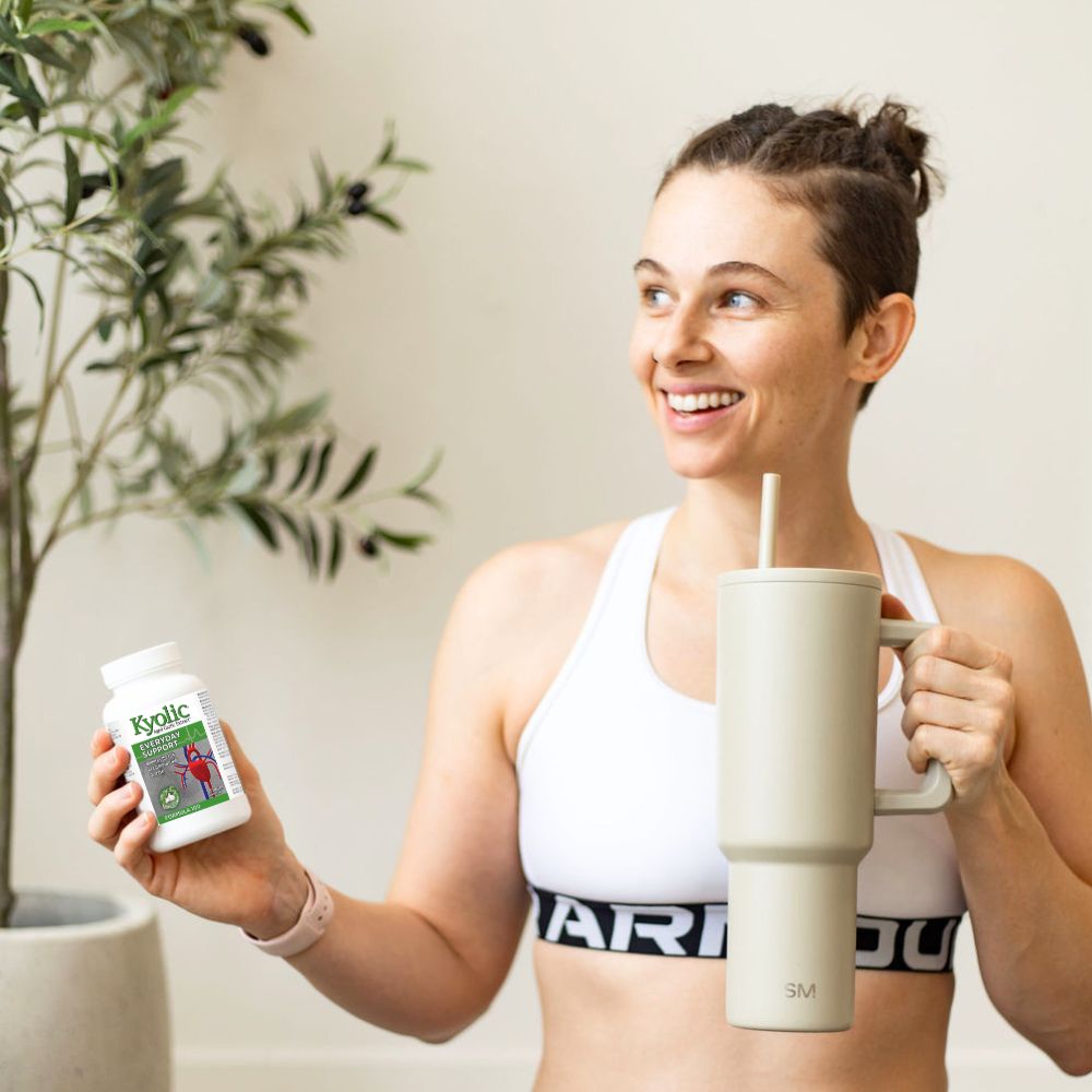 Kyolic Lifestyle Image of a Fit Woman Holding Formula 100 Kyolic Product