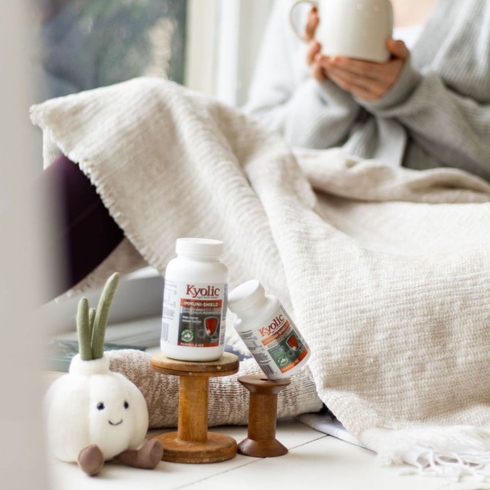 Kyolic Lifestyle Image of ImmuneShield Product Next To A Personal Having Tea